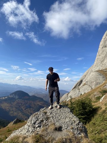 A hiker on a rocky peak