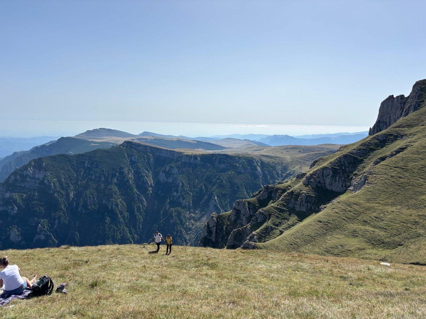 A mountain ridge with two hikers far away