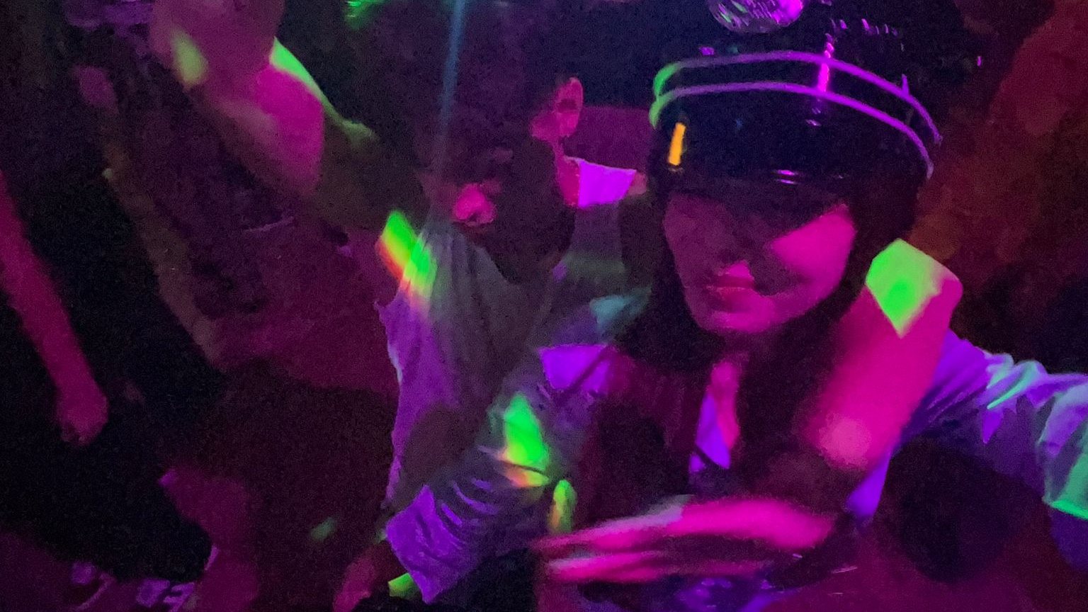 Friends dancing under party lights